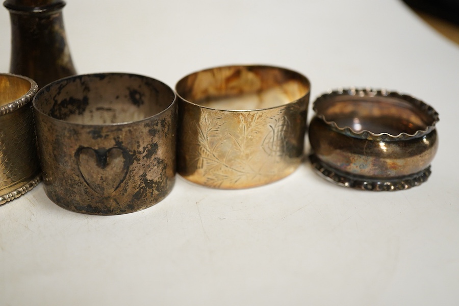 Assorted silver napkin rings, to include a George V engine turned oval pair, Birmingham, 1933, I S Greenberg & Co, initialled, four others and a pepper pot, weight approx. 6.34ozt